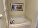 This bathroom is equipped with a luxurious bathtub to unwind and relax at 7668 Wilmington Loop, Kissimmee, FL 34747
