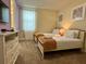 Inviting bedroom featuring twin beds and a dresser at 7668 Wilmington Loop, Kissimmee, FL 34747