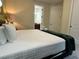 Bedroom features a queen bed with bath access at 7668 Wilmington Loop, Kissimmee, FL 34747