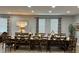 Inviting dining room with long table, seating for many, bright windows, and decorative accents for gatherings at 7668 Wilmington Loop, Kissimmee, FL 34747