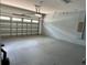 Spacious two car garage with block walls and lighting. Ready for vehicles or extra storage at 7668 Wilmington Loop, Kissimmee, FL 34747