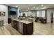 Spacious kitchen island with stainless steel appliances overlooking the dining area at 7668 Wilmington Loop, Kissimmee, FL 34747