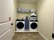 Well-equipped laundry room featuring a washer, dryer, and ample storage space at 7668 Wilmington Loop, Kissimmee, FL 34747