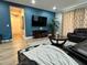 Comfortable living room boasts a plush leather sofa and large screen TV at 7668 Wilmington Loop, Kissimmee, FL 34747