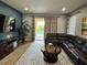 A modern living room leading to an outdoor space at 7668 Wilmington Loop, Kissimmee, FL 34747