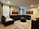 Comfortable living area with a large sectional sofa, area rug, and natural light at 7668 Wilmington Loop, Kissimmee, FL 34747