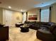 Comfortable living area with a large sectional sofa, area rug, and window at 7668 Wilmington Loop, Kissimmee, FL 34747