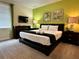 Cozy bedroom featuring a large bed, a TV, and warm lighting at 7668 Wilmington Loop, Kissimmee, FL 34747