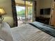 This main bedroom features outdoor views of the private pool at 7668 Wilmington Loop, Kissimmee, FL 34747