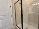 Shower with glass enclosure and tile walls in a bright and airy bathroom at 7668 Wilmington Loop, Kissimmee, FL 34747
