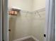 Walk-in closet providing ample storage space with wire shelving and carpeting at 7668 Wilmington Loop, Kissimmee, FL 34747