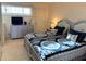 Cozy bedroom featuring two beds with decorative pillows, a dresser, and natural light from the window at 89 S Atlantic Ave # 302, Ormond Beach, FL 32176