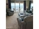 Bright living room featuring sliding glass doors leading to a balcony with ocean views at 89 S Atlantic Ave # 302, Ormond Beach, FL 32176