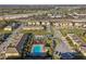 Aerial view of a townhome community with a pool, playground, and proximity to roadways at 9819 Red Eagle Dr, Orlando, FL 32825