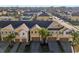 Aerial view of well-maintained townhomes, showcasing meticulous landscaping and private driveways at 9819 Red Eagle Dr, Orlando, FL 32825