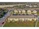 Aerial view of townhomes with rear patios and landscaping, near a highway at 9819 Red Eagle Dr, Orlando, FL 32825
