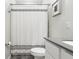 Bathroom featuring a single vanity, gray countertops, white cabinets, and a shower with a patterned curtain at 9819 Red Eagle Dr, Orlando, FL 32825