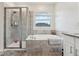 Bathroom includes separate shower, and large bathtub, with tile and a window at 9819 Red Eagle Dr, Orlando, FL 32825