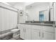 Bathroom featuring double vanity, gray countertops, white cabinets, and a shower with a shower curtain at 9819 Red Eagle Dr, Orlando, FL 32825