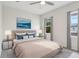 Well-lit bedroom featuring a tufted headboard, bedside tables, and a large window at 9819 Red Eagle Dr, Orlando, FL 32825