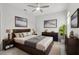 Well-lit bedroom with neutral tones featuring a bed, side tables, and decorative wall art at 9819 Red Eagle Dr, Orlando, FL 32825