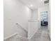 Upstairs hallway with carpeted floors leading to a bedroom at 9819 Red Eagle Dr, Orlando, FL 32825