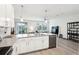 Open concept kitchen with gray countertops, an island, and stainless steel appliances overlooking the living area at 9819 Red Eagle Dr, Orlando, FL 32825