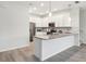 Modern kitchen boasts an island, pendant lights, and stainless steel appliances at 9819 Red Eagle Dr, Orlando, FL 32825