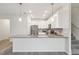 Contemporary kitchen features a center island, modern pendant lights, and stainless steel appliances at 9819 Red Eagle Dr, Orlando, FL 32825