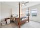 Main bedroom featuring a four-poster bed, ceiling fan, and bright windows at 9819 Red Eagle Dr, Orlando, FL 32825