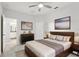 Spacious primary bedroom with a queen size bed, artwork, and ensuite bathroom access at 9819 Red Eagle Dr, Orlando, FL 32825