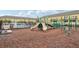 Community playground area with slides, climbing structures, and wood mulch ground cover at 9819 Red Eagle Dr, Orlando, FL 32825