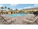 Community pool area with lounge chairs and a covered cabana, perfect for relaxation at 9819 Red Eagle Dr, Orlando, FL 32825