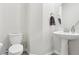 Simple half bathroom with a pedestal sink, round mirror, and gray floors at 9819 Red Eagle Dr, Orlando, FL 32825