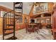 This living room features a spiral staircase, wooden walls and tile floors at 10301 Us Highway 27 # 114, Clermont, FL 34711