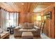 Cozy living room featuring wood-paneled walls, comfortable seating, and natural light at 10301 Us Highway 27 # 114, Clermont, FL 34711