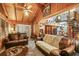 Spacious living room featuring wood paneled walls, tile flooring, and a spiral staircase at 10301 Us Highway 27 # 114, Clermont, FL 34711