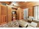 Inviting living room featuring wood-paneled walls, built-in shelving, and stylish, neutral-toned furniture at 10301 Us Highway 27 # 114, Clermont, FL 34711