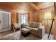 Cozy living room featuring wood-paneled walls, comfortable seating, and natural light at 10301 Us Highway 27 # 114, Clermont, FL 34711