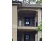 Unit 502 features a cozy covered balcony with dark railings at 1055 Kensington Park Dr # 503, Altamonte Springs, FL 32714