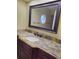 Bathroom features a dark wood vanity with light countertop and large mirror above at 1055 Kensington Park Dr # 503, Altamonte Springs, FL 32714