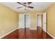 A bedroom with hardwood floors, a ceiling fan, and a closet at 1055 Kensington Park Dr # 503, Altamonte Springs, FL 32714