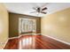 Bedroom featuring a ceiling fan, hardwood floors and a window with shutters at 1055 Kensington Park Dr # 503, Altamonte Springs, FL 32714