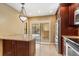 Well-lit kitchen with granite island, stainless appliances and dark cabinetry at 1055 Kensington Park Dr # 503, Altamonte Springs, FL 32714