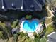 Aerial view of a heart-shaped community pool surrounded by lush greenery and lounge chairs at 1055 Kensington Park Dr # 503, Altamonte Springs, FL 32714