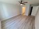 A spacious bedroom featuring a ceiling fan, light gray walls, and wood-look floors at 12913 Sw 82Nd Avenue Rd, Ocala, FL 34473