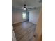 A bedroom featuring a ceiling fan, light gray walls, and wood-look floors at 12913 Sw 82Nd Avenue Rd, Ocala, FL 34473