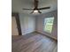 A bedroom featuring a ceiling fan, closet, light gray walls, and wood-look floors at 12913 Sw 82Nd Avenue Rd, Ocala, FL 34473