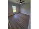 A bedroom featuring a ceiling fan, light gray walls, and wood-look floors at 12913 Sw 82Nd Avenue Rd, Ocala, FL 34473