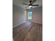 Bedroom featuring wood-look floors, neutral colored walls, and a ceiling fan at 12913 Sw 82Nd Avenue Rd, Ocala, FL 34473